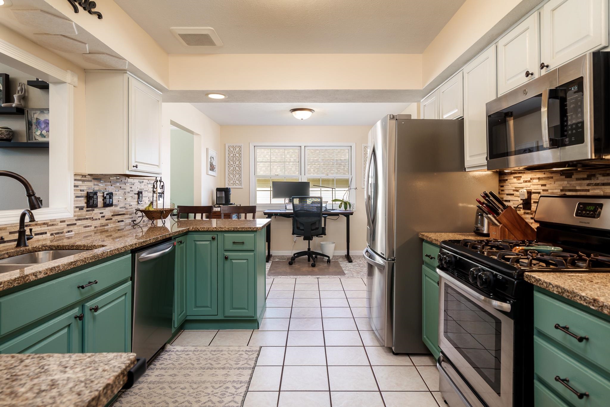 651 Genoa Street Cherry Valley, IL 61016 - Photo 6 of 70 a kitchen with a sink a stove and refrigerator
