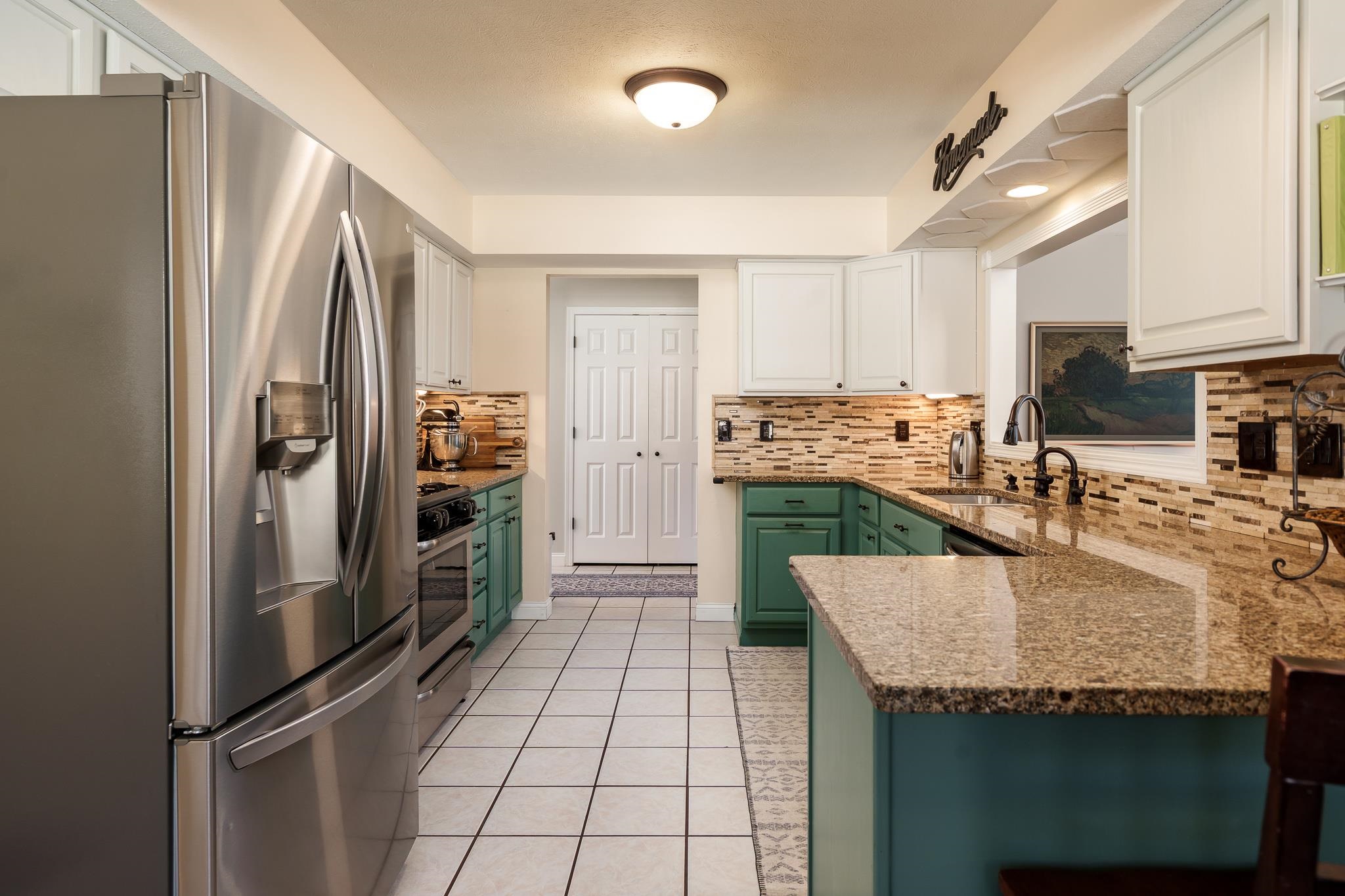 651 Genoa Street Cherry Valley, IL 61016 - Photo 61 of 70 a kitchen with stainless steel appliances granite countertop a refrigerator a stove and a sink