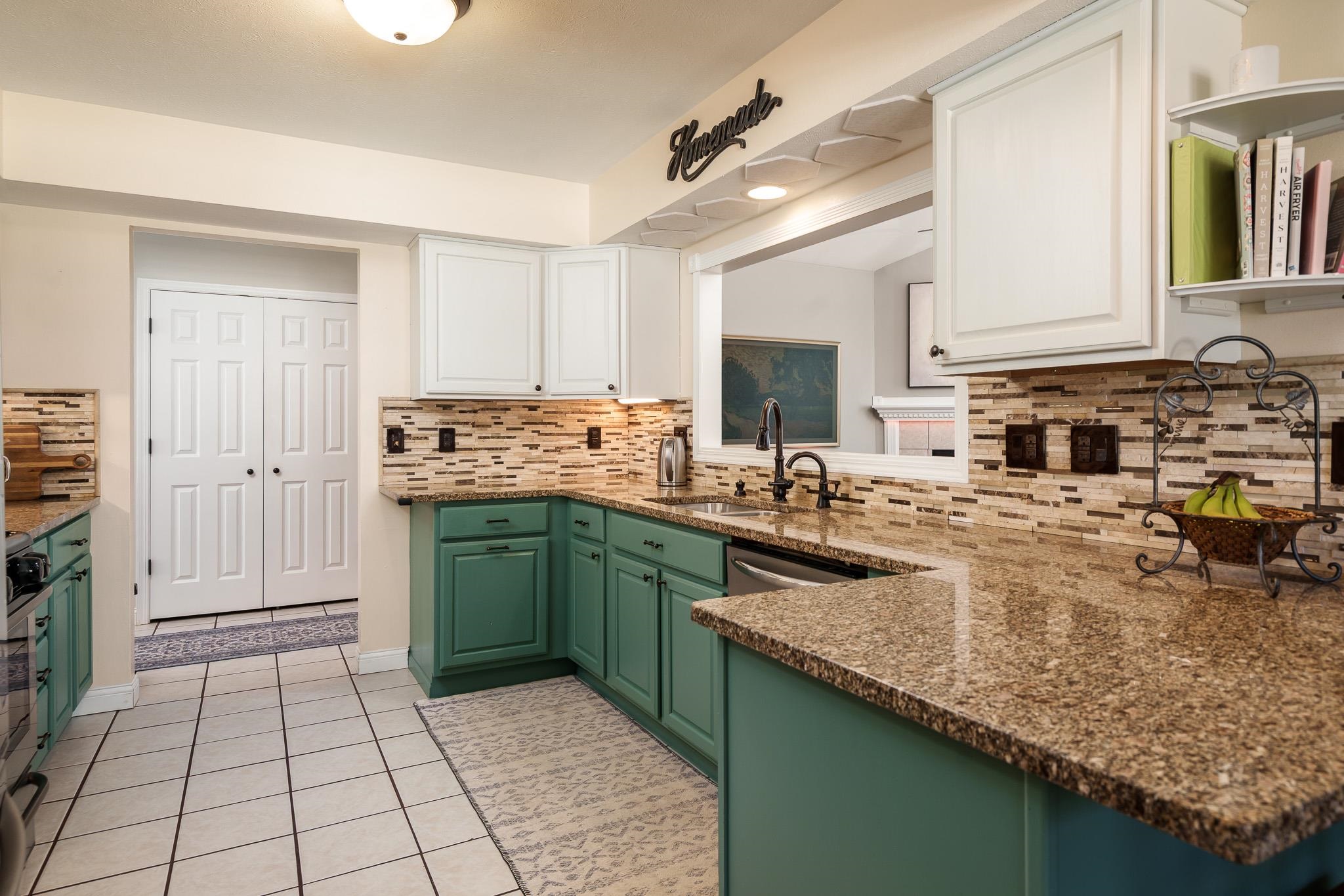 651 Genoa Street Cherry Valley, IL 61016 - Photo 62 of 70 a kitchen with kitchen island granite countertop a sink counter top space and cabinets