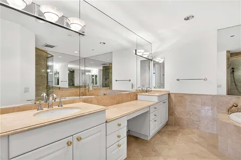 a spacious bathroom with a double vanity sink mirror and double