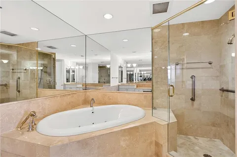 a bathroom with a tub and a shower