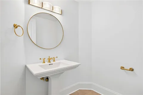 a bathroom with a sink a mirror and a toilet