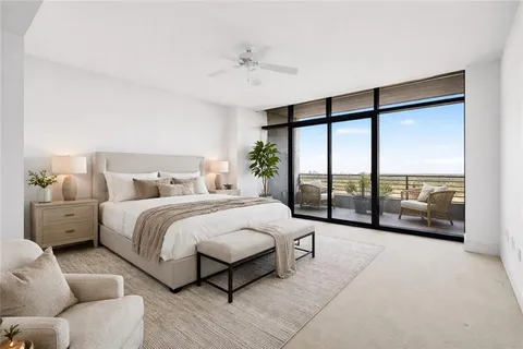 a spacious bedroom with a bed and a large window