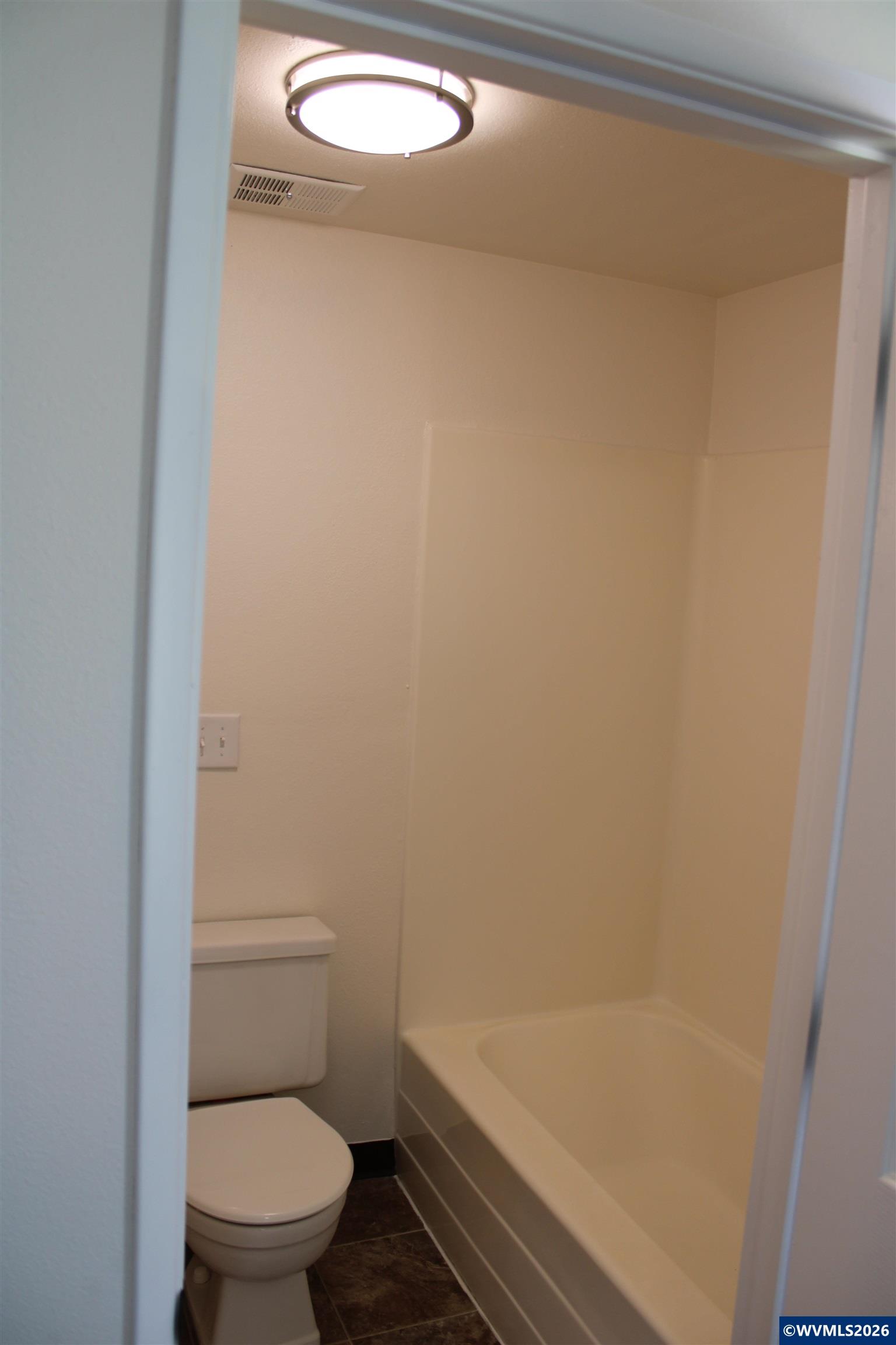 6259 Chapman Place Southwest Albany, OR 97321 - Photo 12 of 21 a bathroom with a granite countertop toilet and a bathtub