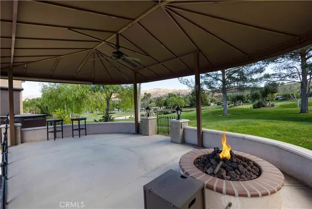 a patio with a table and chairs under an umbrella