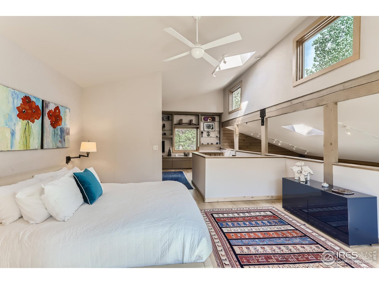 156 Betasso Road Boulder, CO 80302 - Photo 16 of 38 a bedroom with a large bed and a chandelier