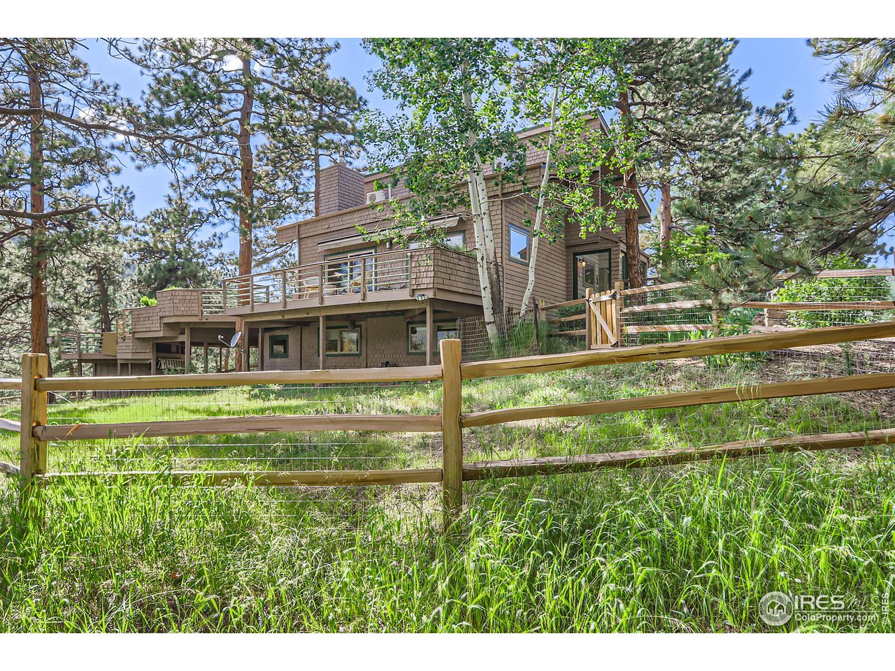 156 Betasso Road Boulder, CO 80302 - Photo 26 of 38 a view of a house with a big yard and large trees