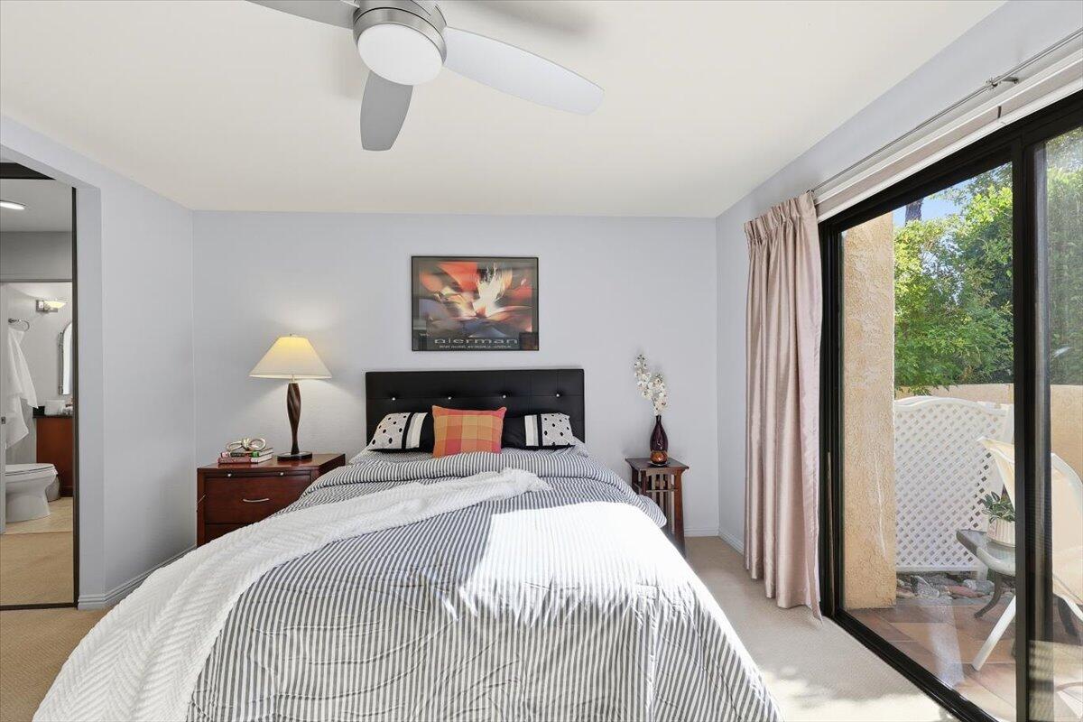 200 East Racquet Club Road, Unit 2 Palm Springs, CA 92262 - Photo 17 of 56 a bedroom with a bed and a large window
