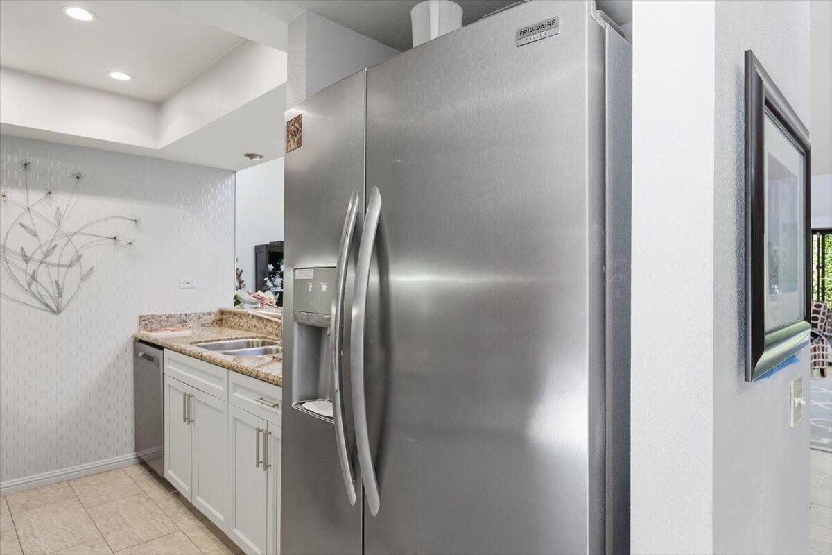 200 East Racquet Club Road, Unit 2 Palm Springs, CA 92262 - Photo 24 of 56 a kitchen with stainless steel appliances granite countertop a refrigerator and a stove