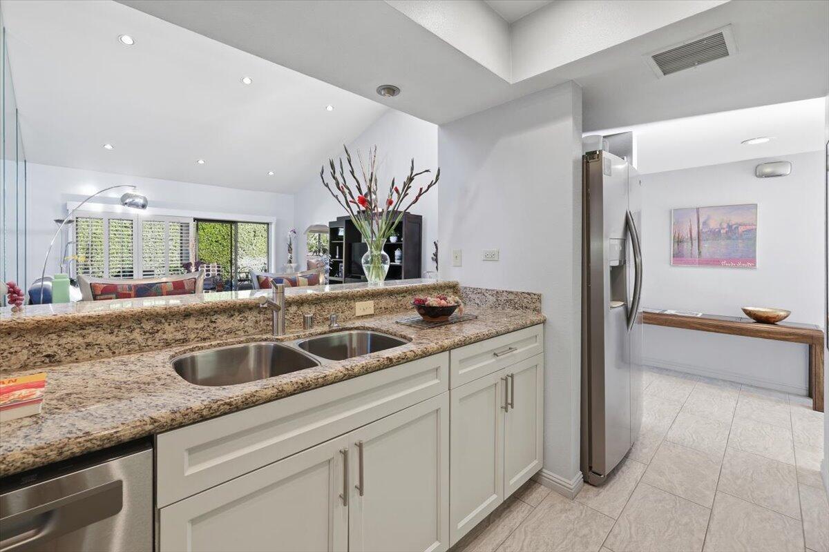 200 East Racquet Club Road, Unit 2 Palm Springs, CA 92262 - Photo 27 of 56 a kitchen with a sink and a refrigerator
