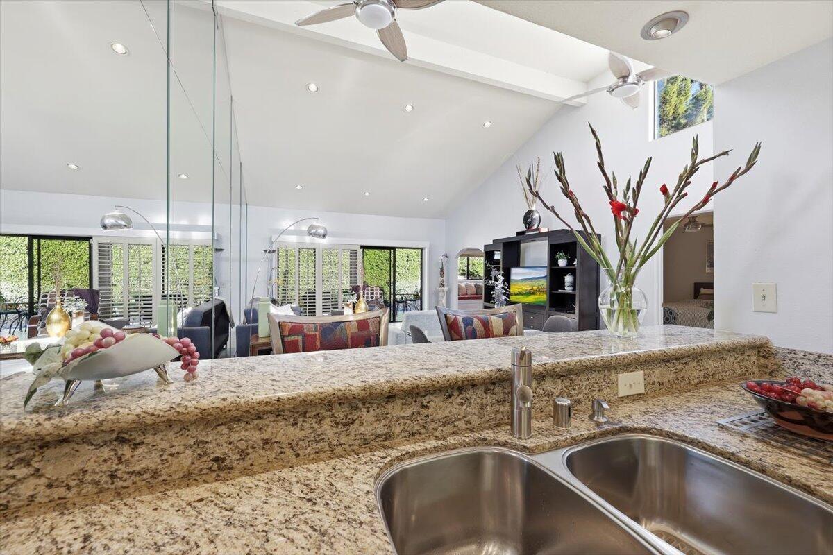 200 East Racquet Club Road, Unit 2 Palm Springs, CA 92262 - Photo 28 of 56 a kitchen with a sink potted plant and a large window