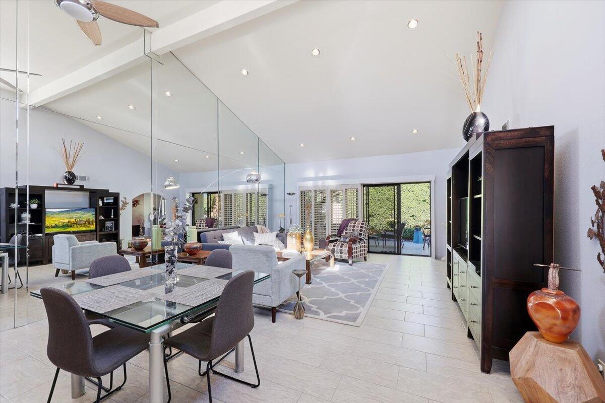 200 East Racquet Club Road, Unit 2 Palm Springs, CA 92262 - Photo 29 of 56 a view of a dining room with furniture one side kitchen view and wooden floor