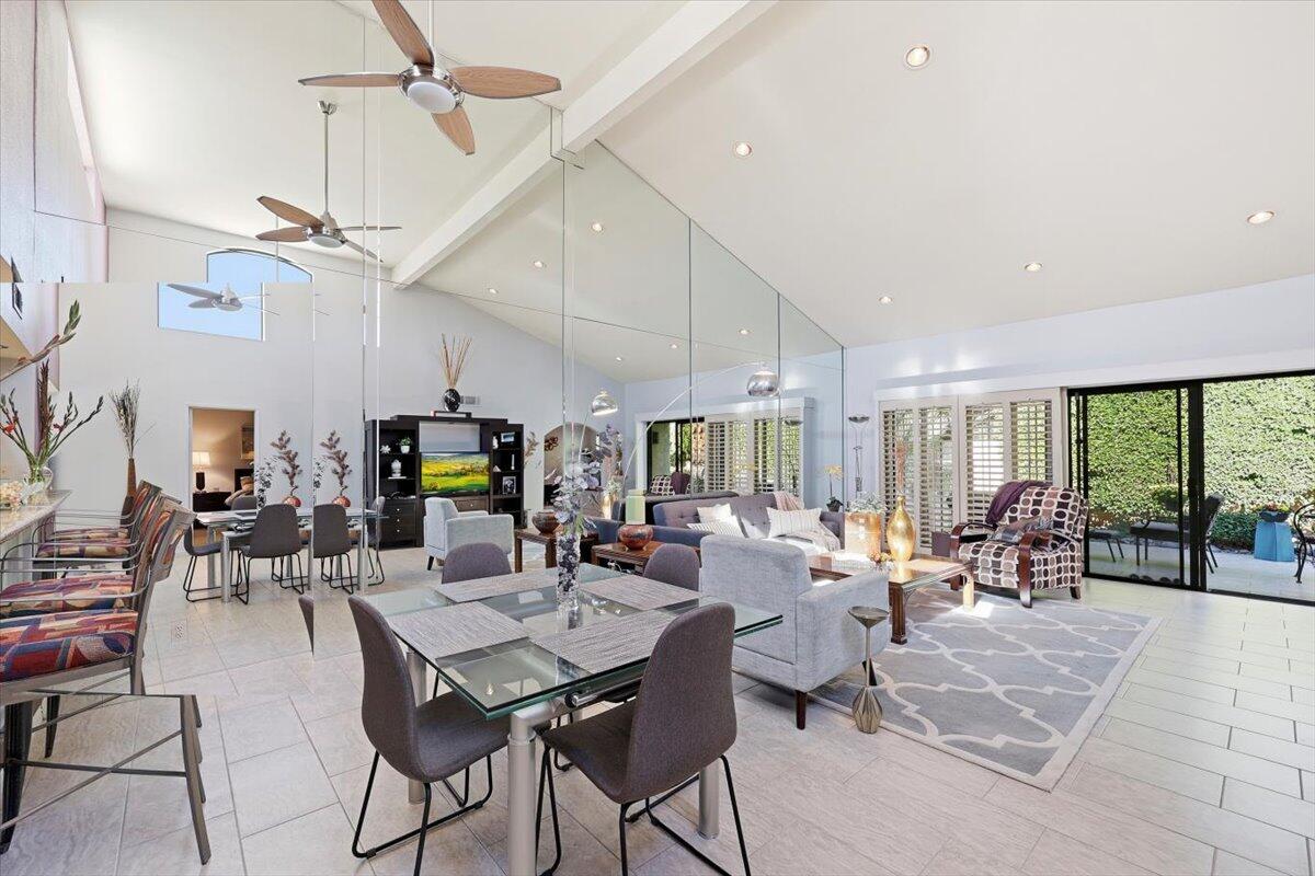 200 East Racquet Club Road, Unit 2 Palm Springs, CA 92262 - Photo 30 of 56 a room with lots of tables a large window and chairs