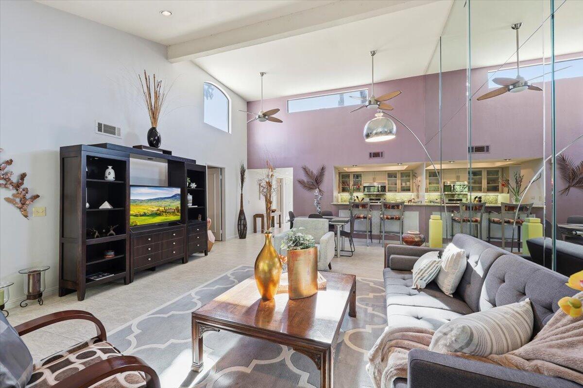 200 East Racquet Club Road, Unit 2 Palm Springs, CA 92262 - Photo 32 of 56 a living room with furniture and a flat screen tv
