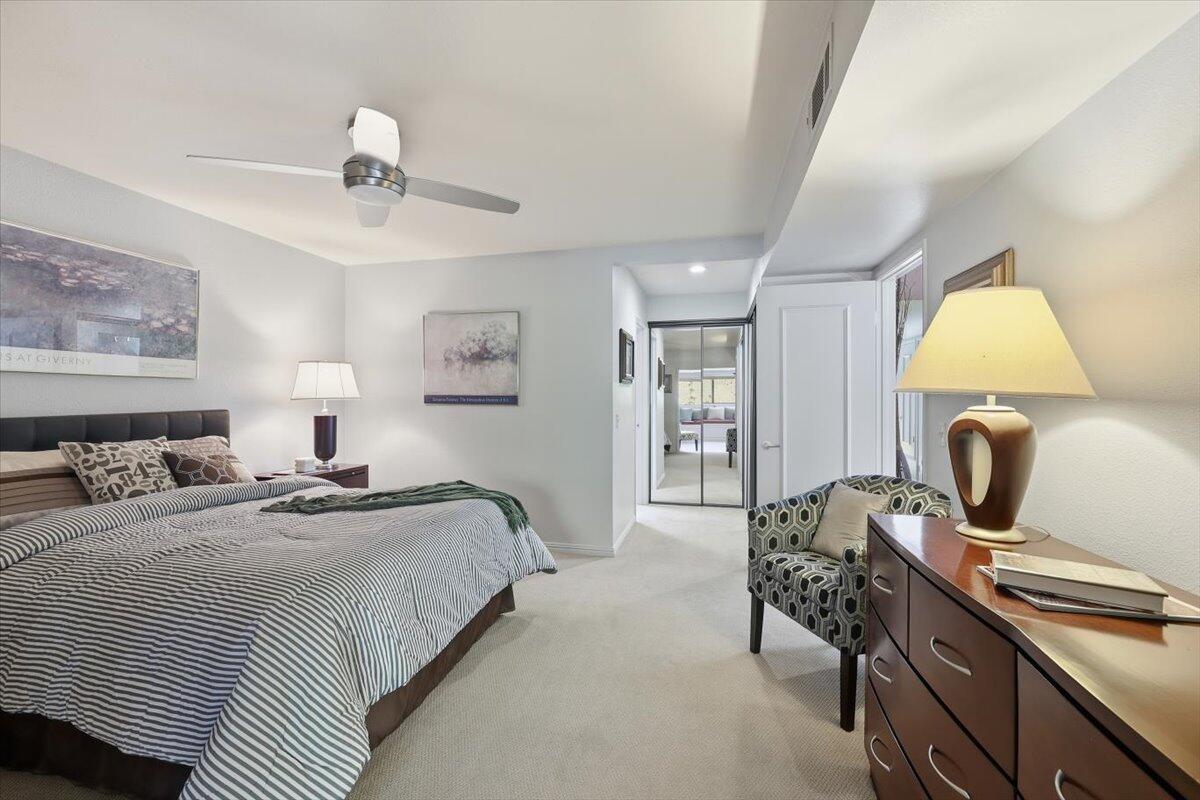 200 East Racquet Club Road, Unit 2 Palm Springs, CA 92262 - Photo 39 of 56 a bedroom with a bed and wooden floor