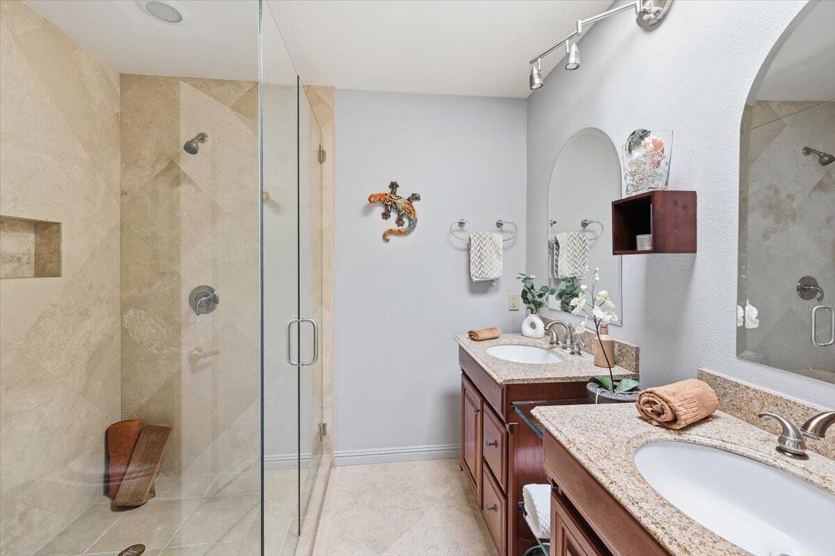 200 East Racquet Club Road, Unit 2 Palm Springs, CA 92262 - Photo 42 of 56 a bathroom with a granite countertop sink a mirror and shower