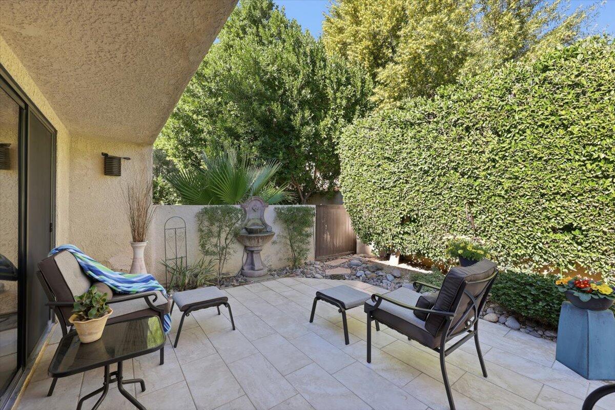 200 East Racquet Club Road, Unit 2 Palm Springs, CA 92262 - Photo 44 of 56 a view of a chairs and table in the back yard of the house