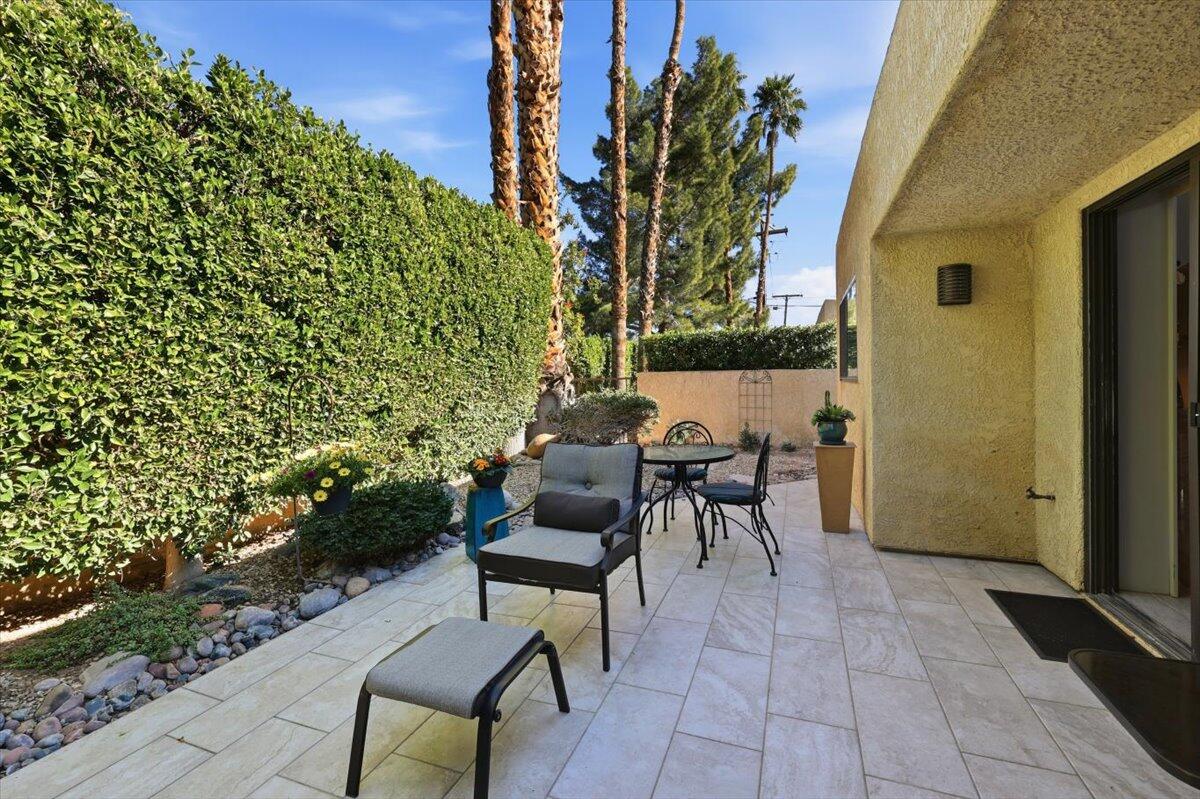 200 East Racquet Club Road, Unit 2 Palm Springs, CA 92262 - Photo 45 of 56 a view of a patio with table and chairs and potted plants