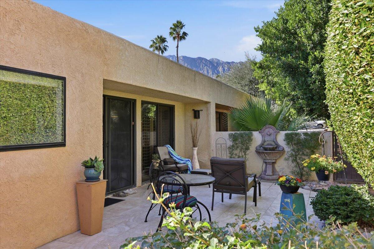 200 East Racquet Club Road, Unit 2 Palm Springs, CA 92262 - Photo 48 of 56 a view of a patio with table and chairs and potted plants