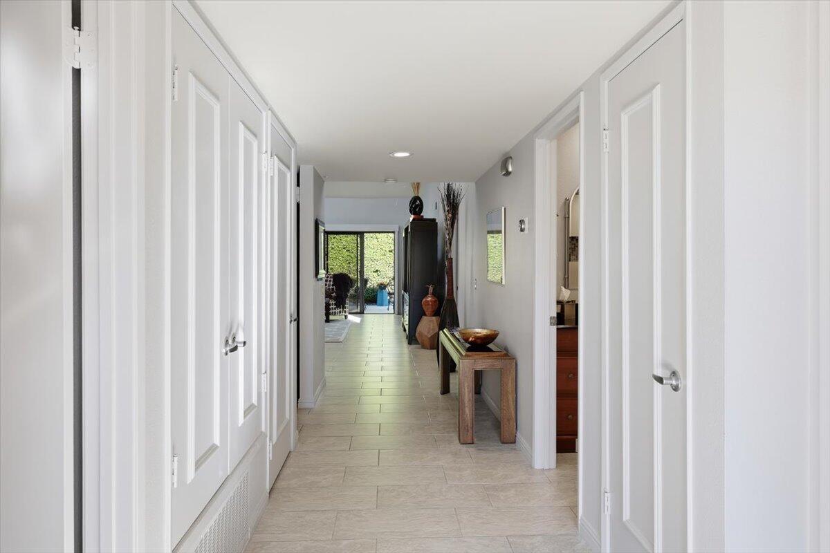 200 East Racquet Club Road, Unit 2 Palm Springs, CA 92262 - Photo 9 of 56 a view of a hallway with living room and furniture