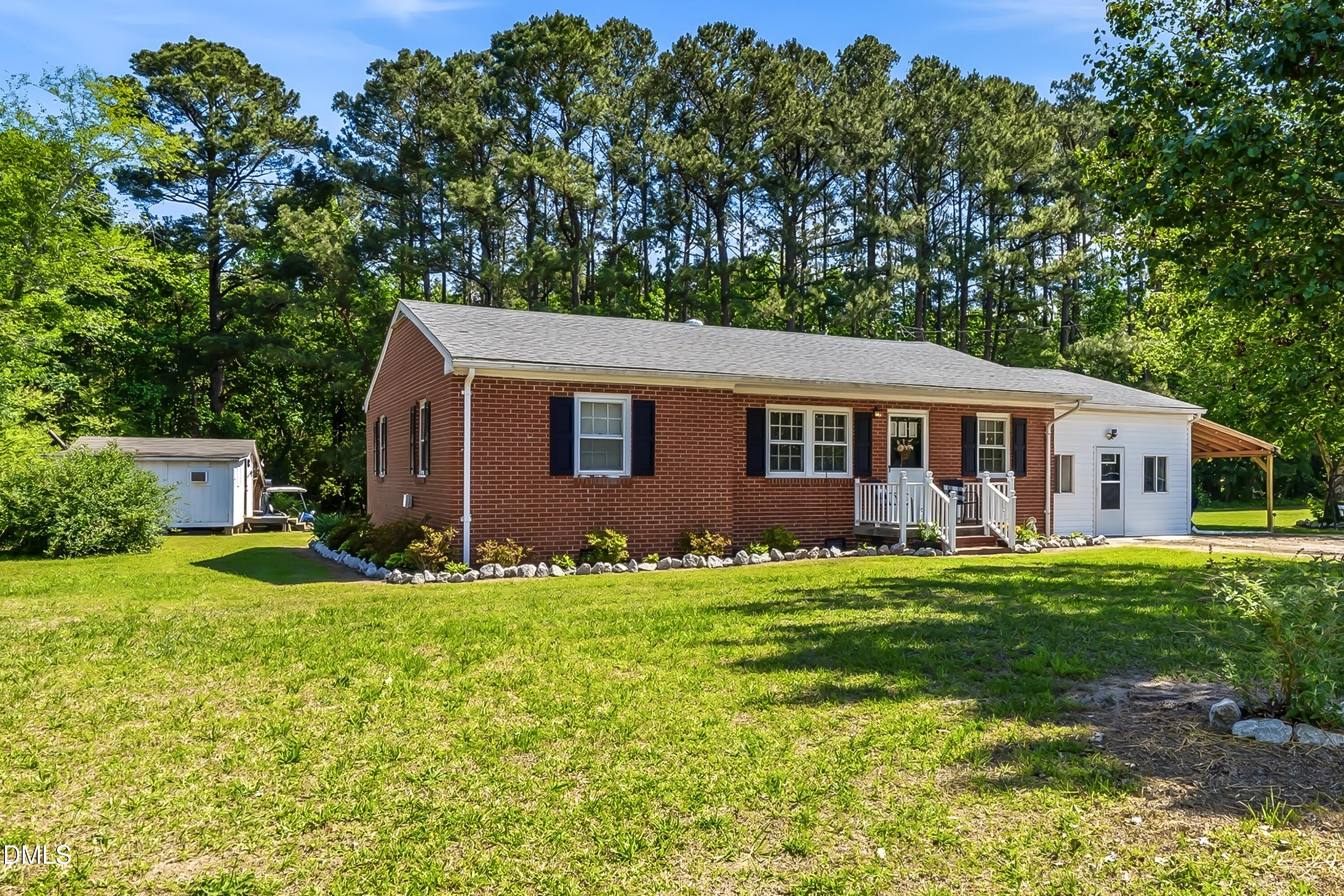4967 Highway 581 Spring Hope, NC 27882 - Photo 5 of 44 a backyard of a house with potted plants and large tree