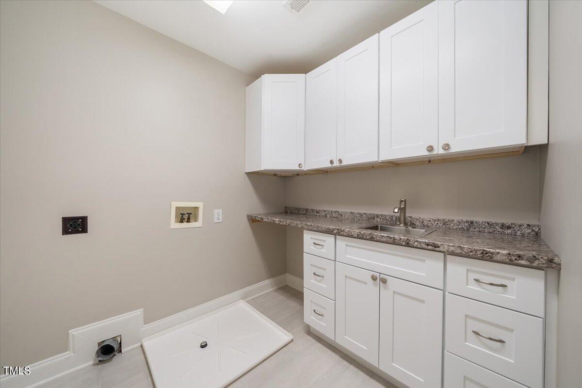 6300 Swallow Cove Lane Raleigh, NC 27614 - Photo 42 of 67 a bathroom with a granite countertop sink and cabinets