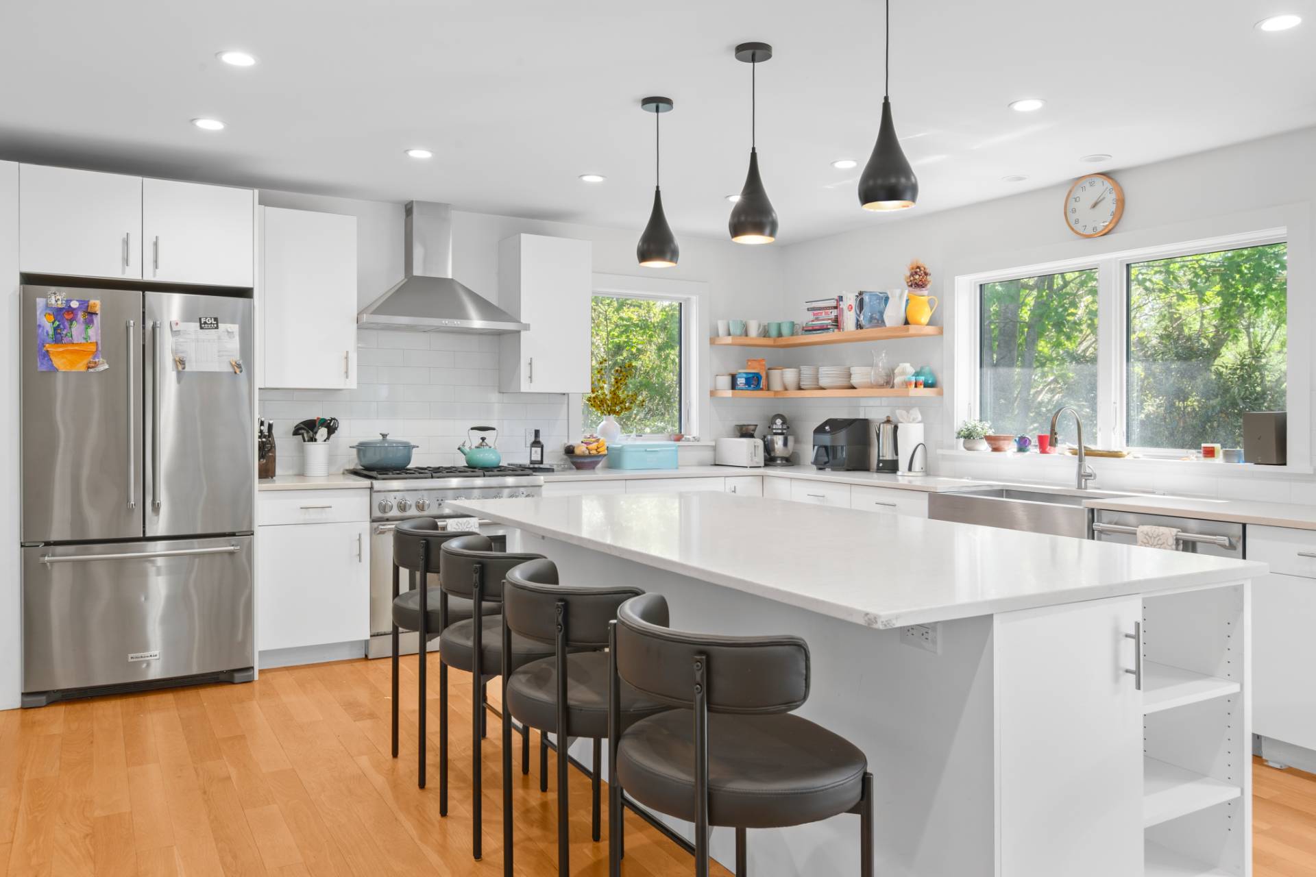 87 Accabonac Road East Hampton, NY 11937 - Photo 4 of 21 a kitchen with stainless steel appliances granite countertop a sink a stove a refrigerator and island with wooden floor