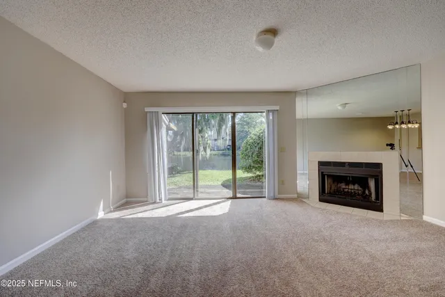 a view of empty room with a fireplace
