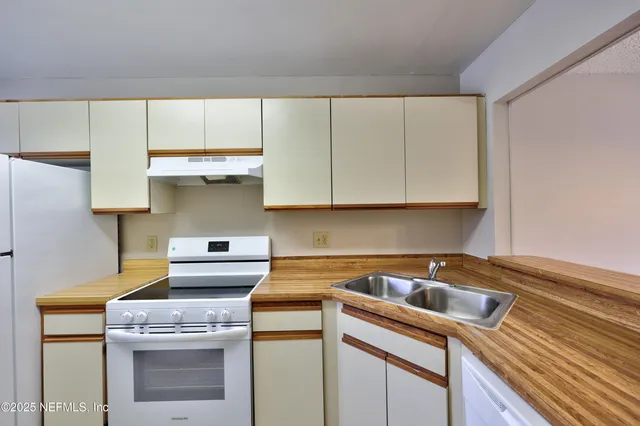 a kitchen with a stove and a sink