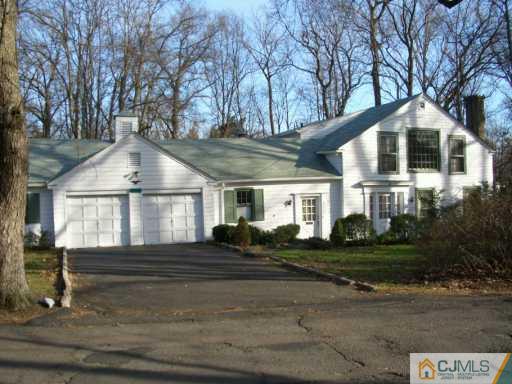 1 Devon Road Colonia, NJ 07067 - Photo 2 of 8 a front view of a house with a yard