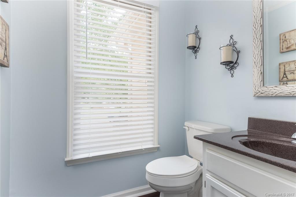 1205 Driftway Point Road Matthews, NC 28105 - Photo 11 of 24 a white toilet sitting next to a bathroom sink