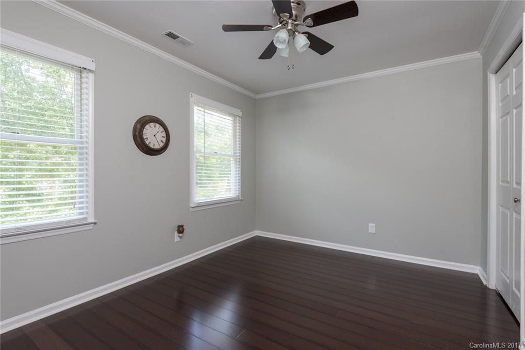 1205 Driftway Point Road Matthews, NC 28105 - Photo 17 of 24 a view of an empty room with wooden floor and a window
