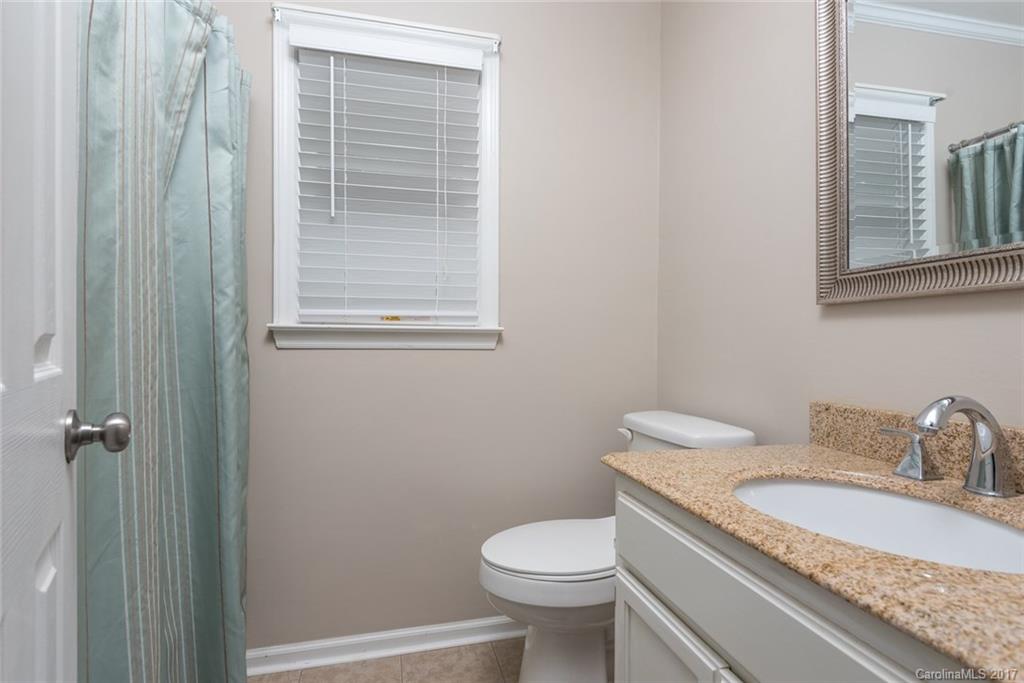1205 Driftway Point Road Matthews, NC 28105 - Photo 18 of 24 a bathroom with a granite countertop toilet and sink