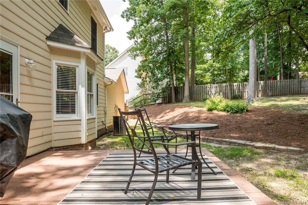 1205 Driftway Point Road Matthews, NC 28105 - Photo 19 of 24 a view of a patio with table and chairs and wooden fence