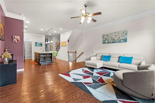 a living room with furniture and wooden floor