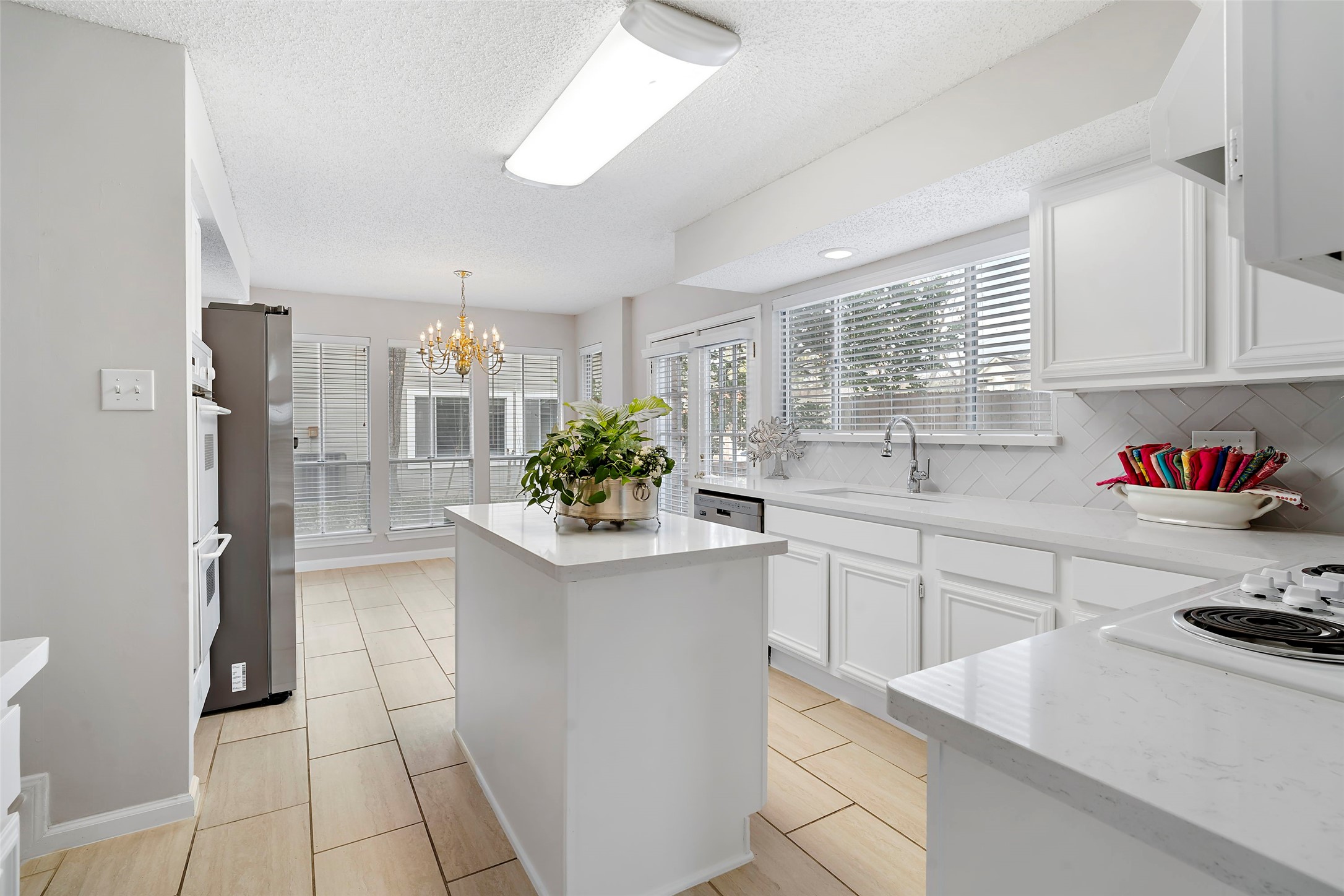 12800 Briar Forest Drive, Unit 48 Houston, TX 77077 - Photo 17 of 36 a kitchen with a sink stove and cabinets