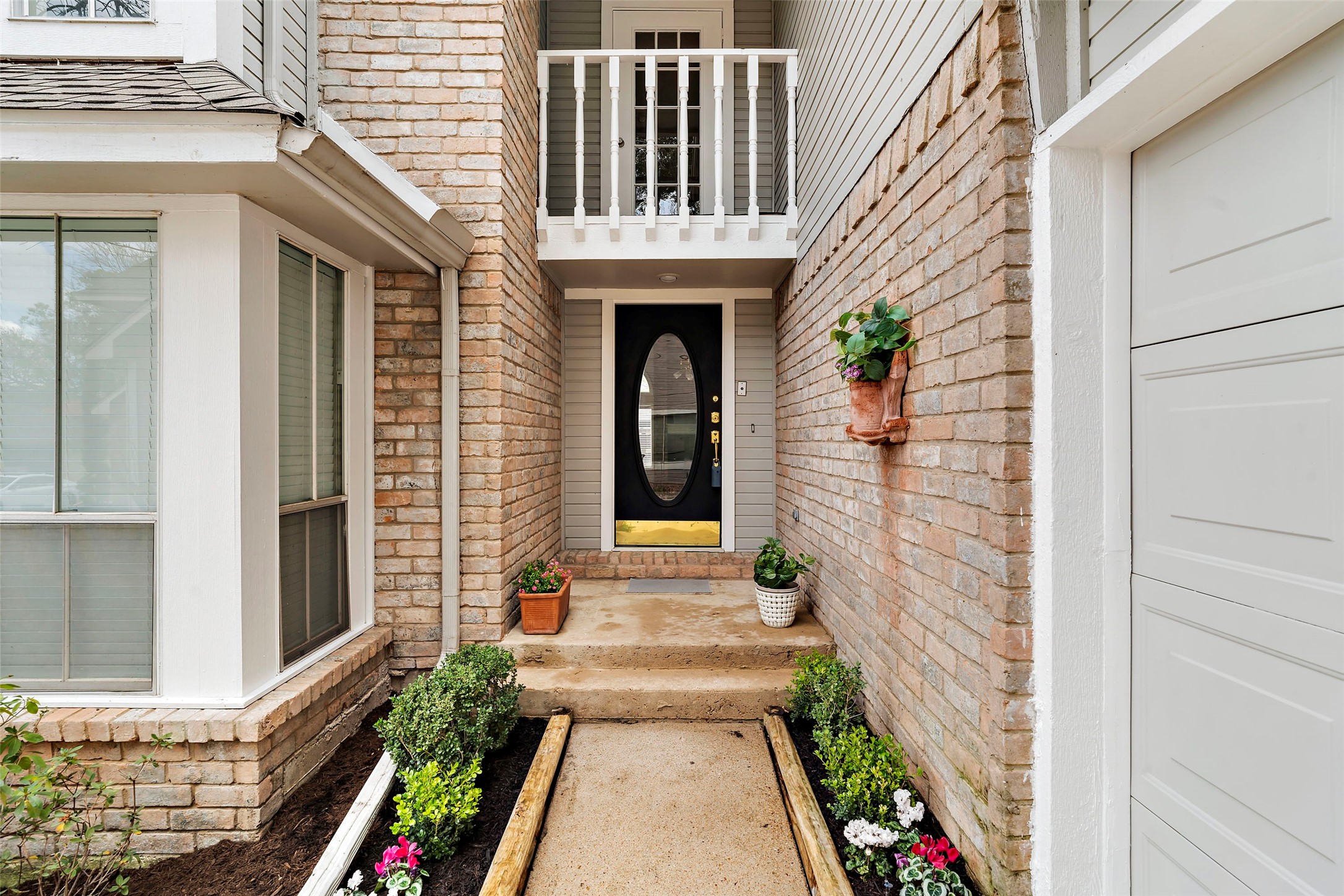 12800 Briar Forest Drive, Unit 48 Houston, TX 77077 - Photo 2 of 36 a front view of a house with a porch