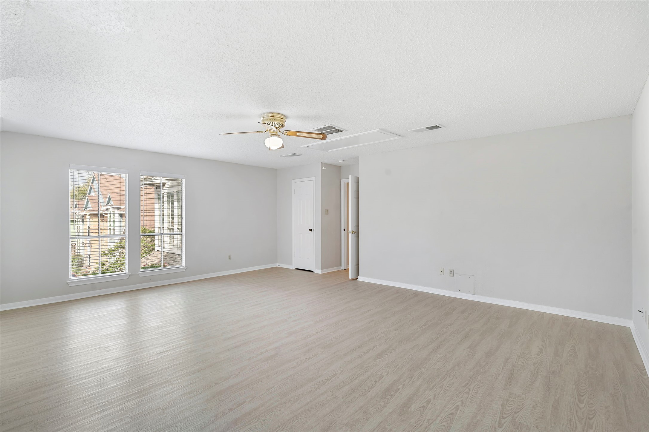 12800 Briar Forest Drive, Unit 48 Houston, TX 77077 - Photo 28 of 36 a view of an empty room with wooden floor and a window
