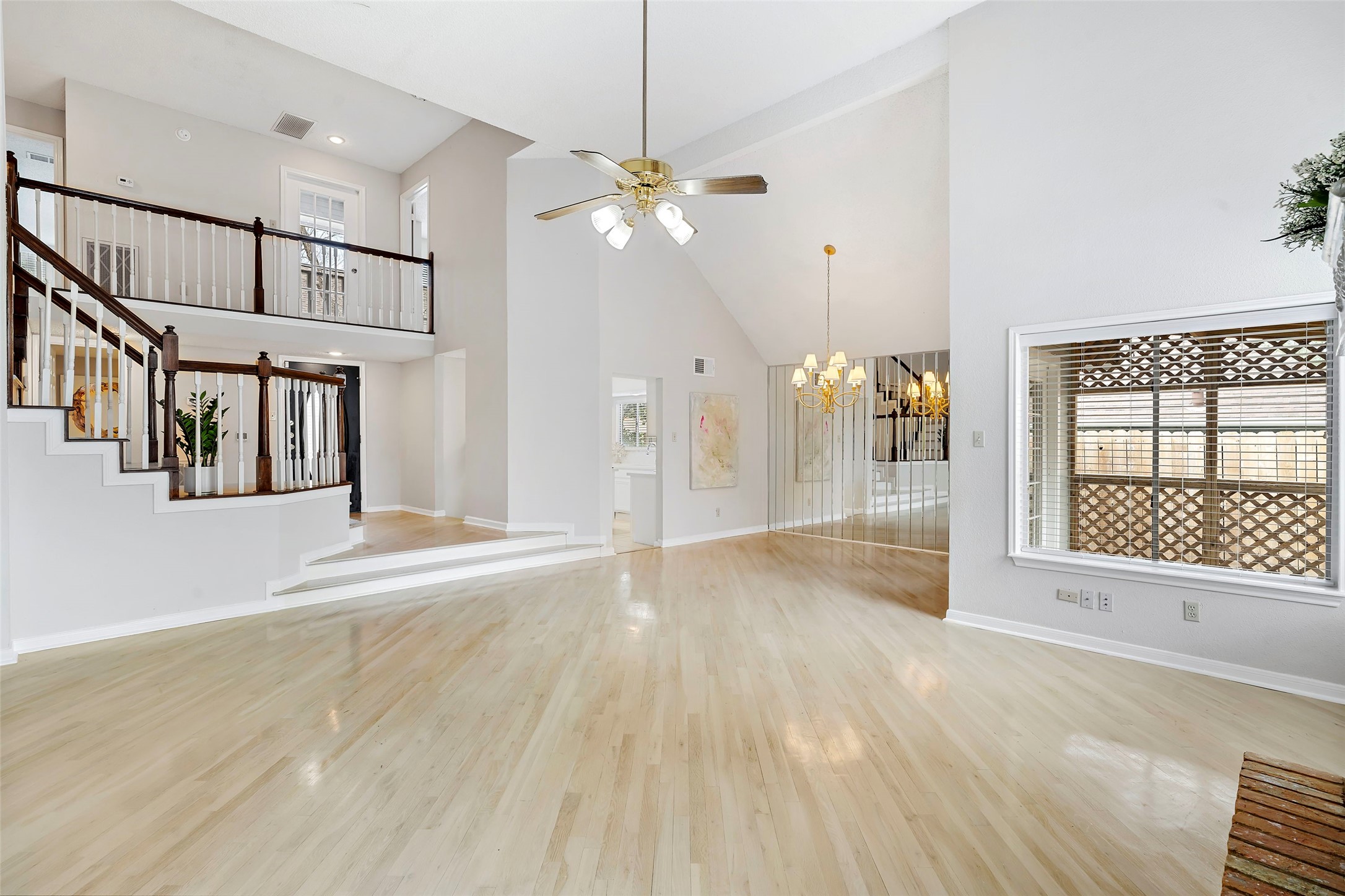 12800 Briar Forest Drive, Unit 48 Houston, TX 77077 - Photo 4 of 36 a view of a livingroom with wooden floor and a ceiling fan