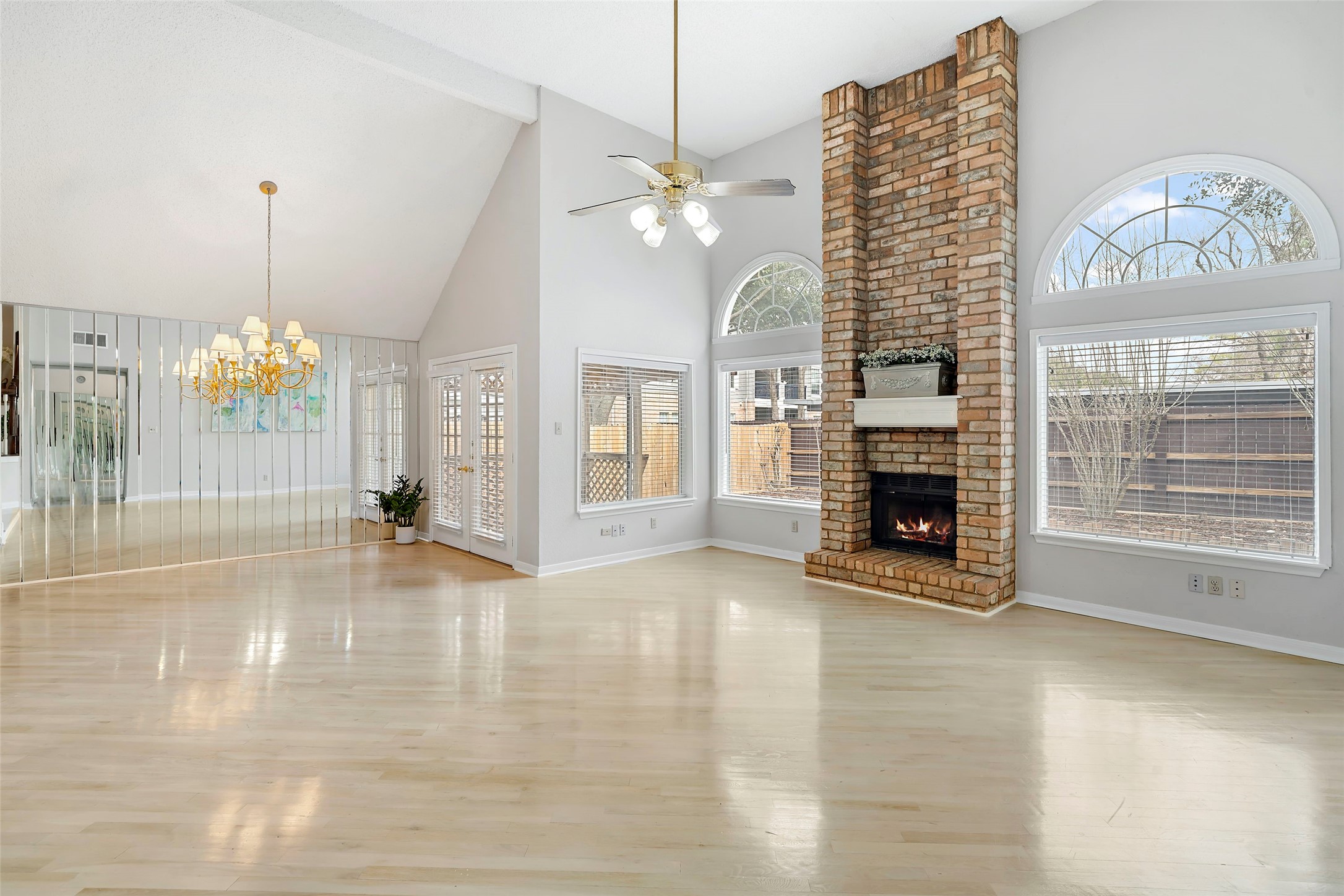 12800 Briar Forest Drive, Unit 48 Houston, TX 77077 - Photo 7 of 36 a view of an empty room with a fireplace and chandelier
