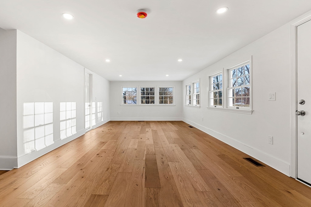 34 Central Street, Unit 1 Rowley, MA 01969 - Photo 12 of 27 a view of an empty room with wooden floor and a window