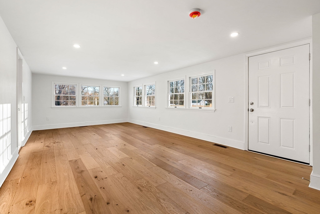 34 Central Street, Unit 1 Rowley, MA 01969 - Photo 13 of 27 an empty room with wooden floor and windows