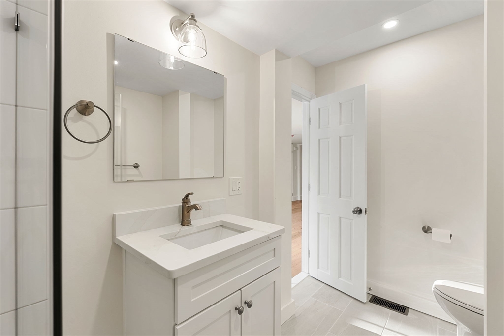 34 Central Street, Unit 1 Rowley, MA 01969 - Photo 16 of 27 a bathroom with a sink a toilet and shower