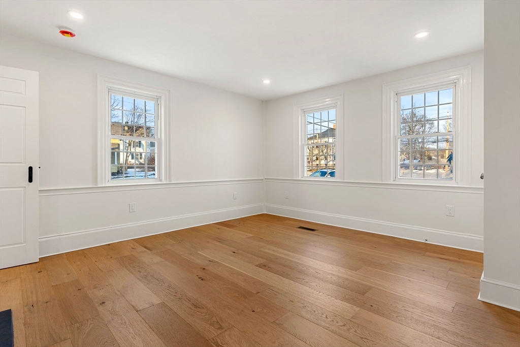 34 Central Street, Unit 1 Rowley, MA 01969 - Photo 19 of 27 an empty room with wooden floor and windows