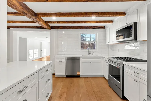 a kitchen with stainless steel appliances granite countertop a stove and a sink