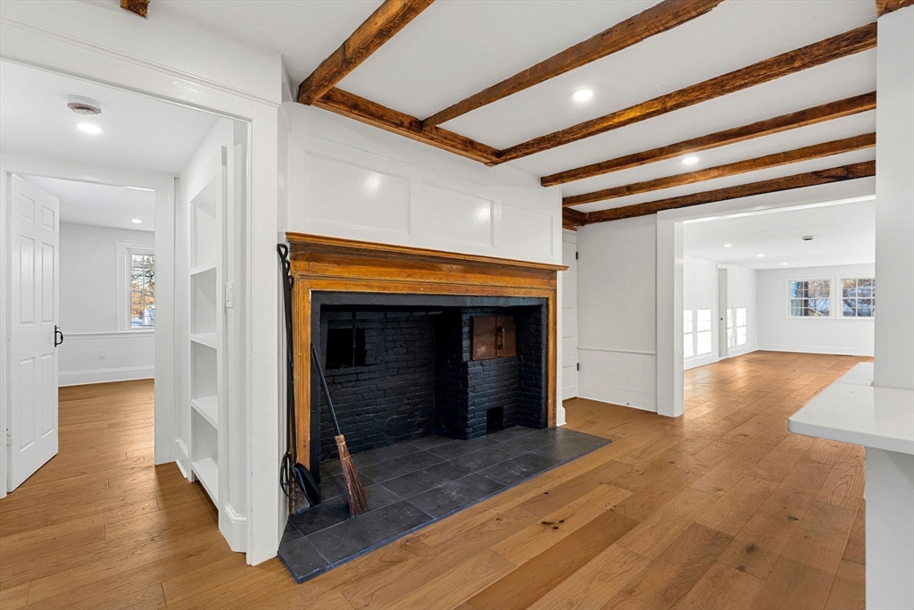 34 Central Street, Unit 1 Rowley, MA 01969 - Photo 9 of 27 a view of a hallway with wooden floor and a living room