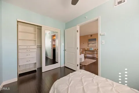 a living room with furniture flowerpot and wooden floor