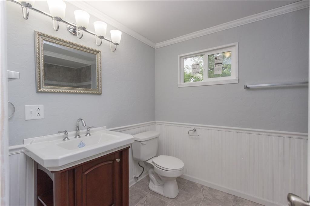 1153 Pentland Avenue Rochester, PA 15074 - Photo 13 of 23 Completely renovated full bath with ceramic tile, new vanity, light fixtures, bead board, chair rail, and so much more!