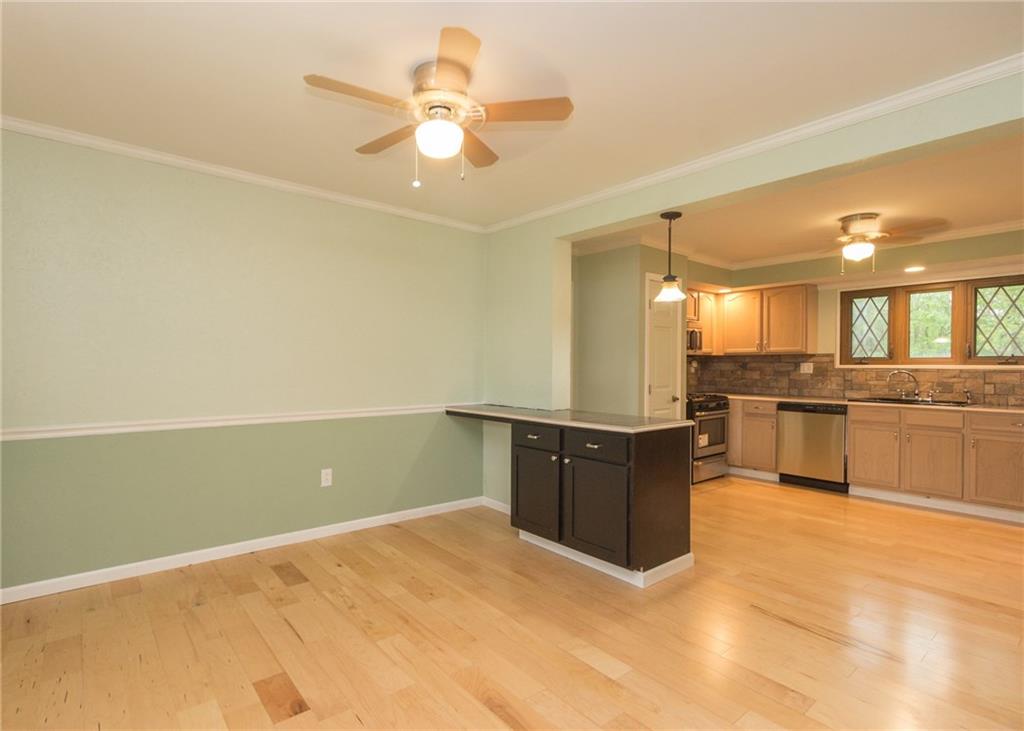 1153 Pentland Avenue Rochester, PA 15074 - Photo 5 of 23 The dining room has been opened to the kitchen to create a great flow for entertaining. Chair rail, new fixtures and great island for extra storage or seating.