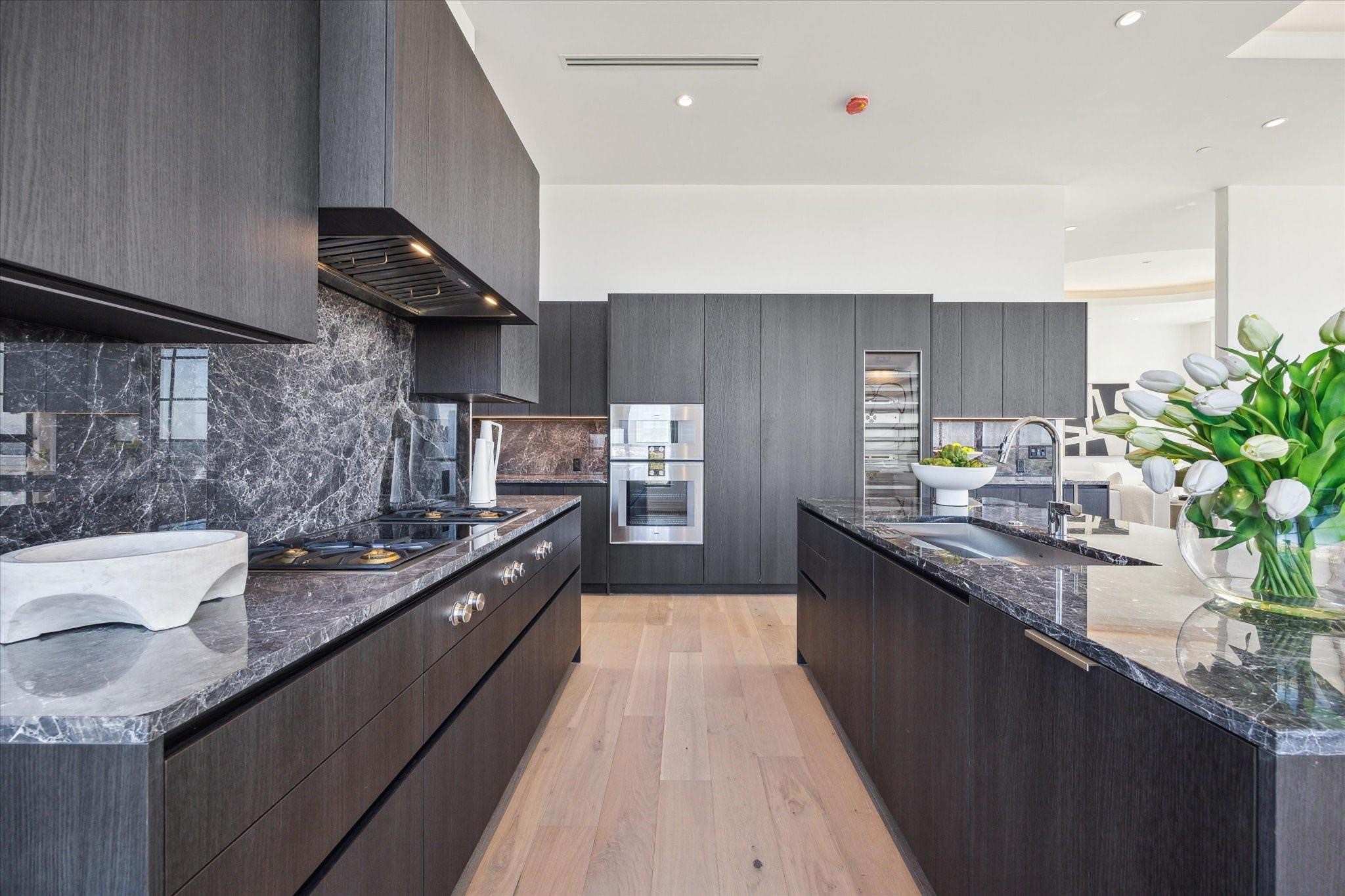 2360 Rice Boulevard, Unit PH1201 Houston, TX 77005 - Photo 12 of 21 a kitchen with stainless steel appliances granite countertop a sink a stove and a wooden floors